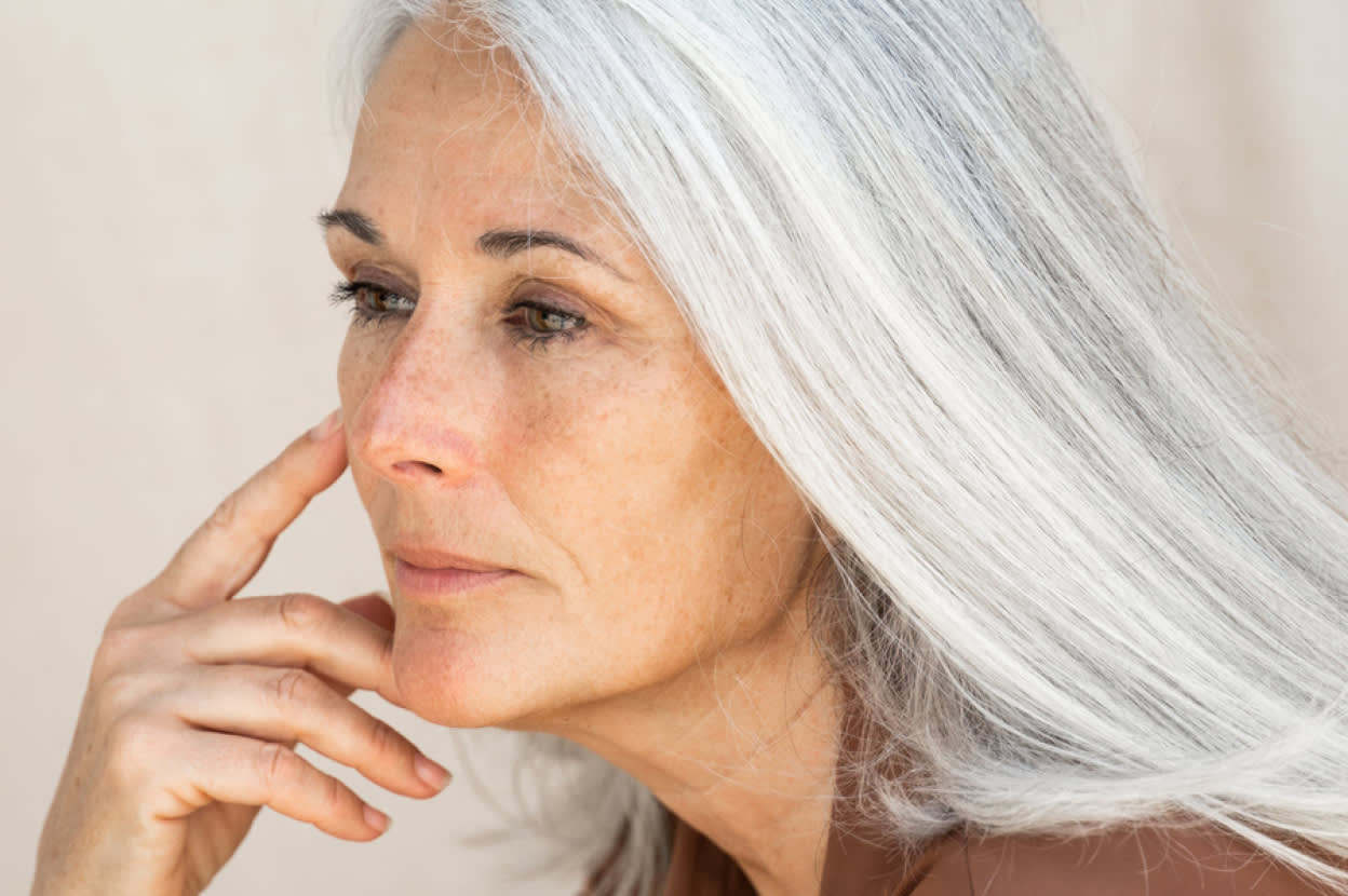 An older woman with silver hair looking off into the distance, representing the connection between mouth health and cognitive impairment – Viome Oral Health Intelligence Test